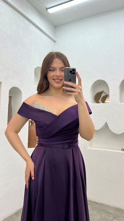 فستان سهرة من الساتان بلون البرقوق مزين بأحجار كريمة على الصدر والحزام 