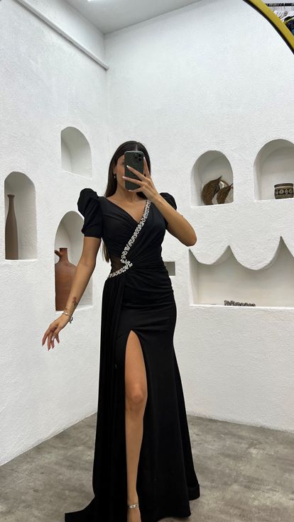 Schwarzes  mit Ballonärmeln und Verzierungen versehenes Abendkleid mit Schlitz