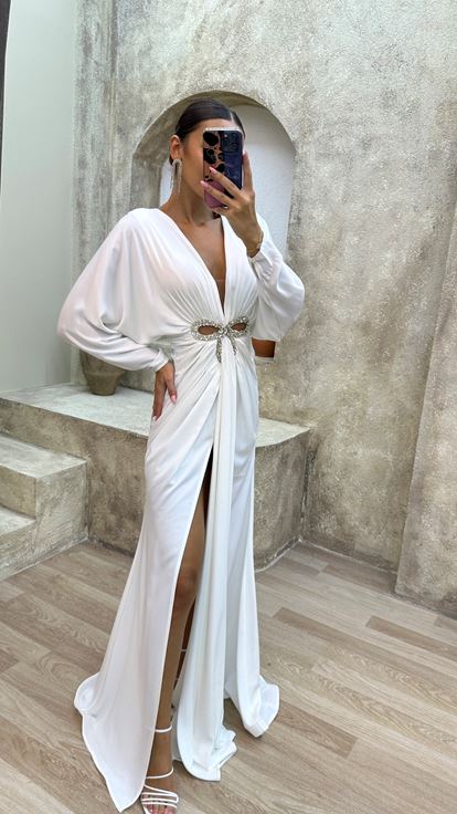 فستان سهرة أبيض بياقة على شكل حرف V مزين بتفاصيل عند الخصر وفتحة جانبية