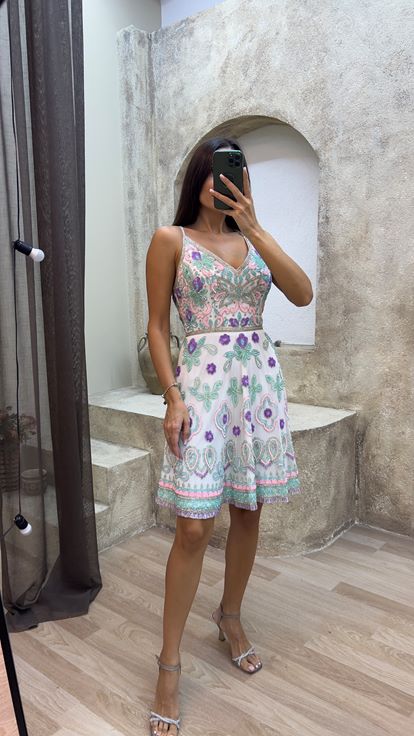 فستان أبيض بتصميم خاص مطرز ومزين بشراشيب