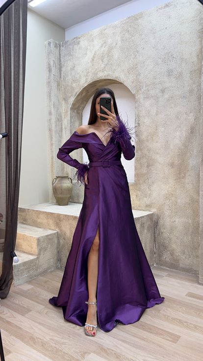 Plum colored boat neck evening dress with feather detail on the sleeves 