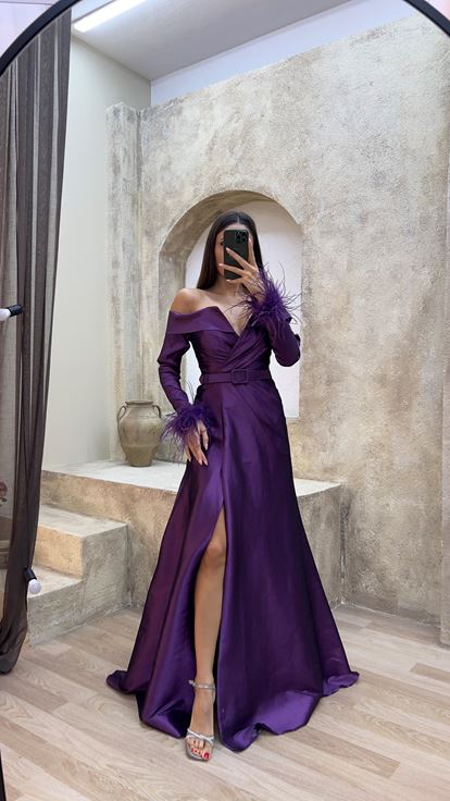 Plum colored boat neck evening dress with feather detail on the sleeves 