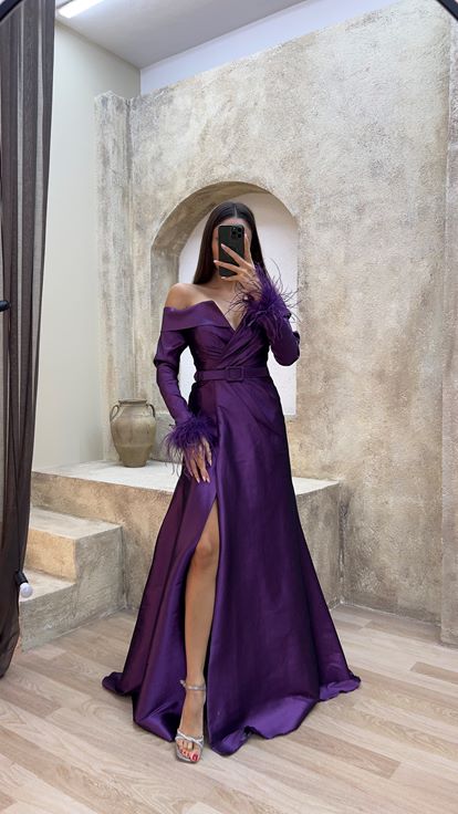 Plum colored boat neck evening dress with feather detail on the sleeves 