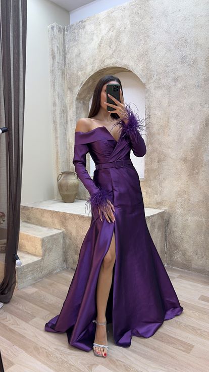 Plum colored boat neck evening dress with feather detail on the sleeves 