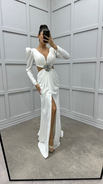فستان أبيض من الساتان بتصميم مطوي عند الصدر وتفاصيل شفافة عند الخصر 