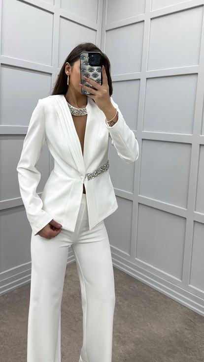 Conjunto de dos piezas blanco con adornos de piedras en el pecho y la cintura 