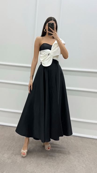 فستان أسود بكتف واحد مزين بفيونكة عند الصدر