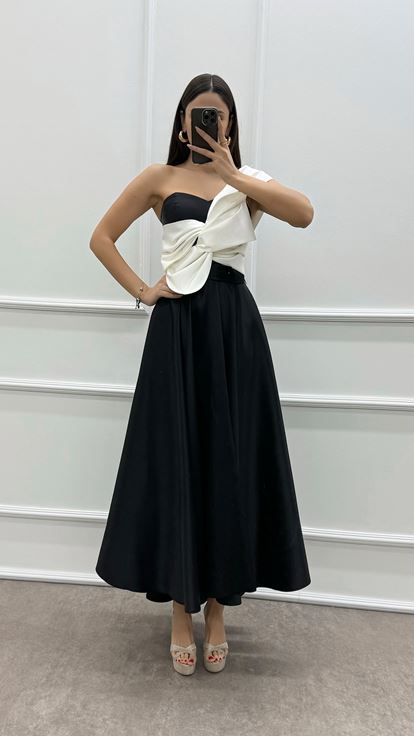 فستان أسود بكتف واحد مزين بفيونكة عند الصدر