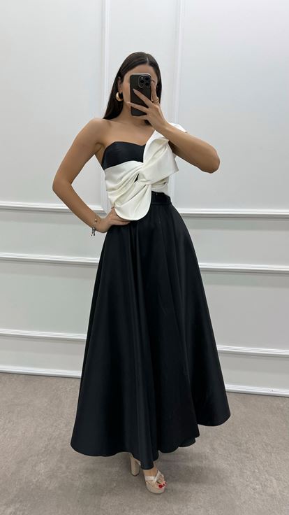 فستان أسود بكتف واحد مزين بفيونكة عند الصدر