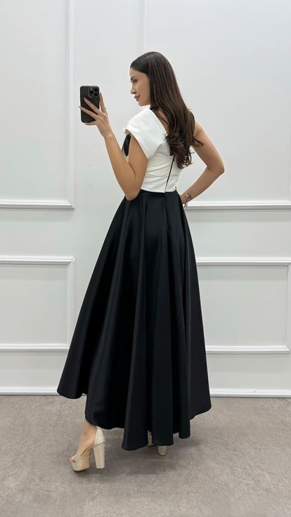 فستان أسود بكتف واحد مزين بفيونكة عند الصدر