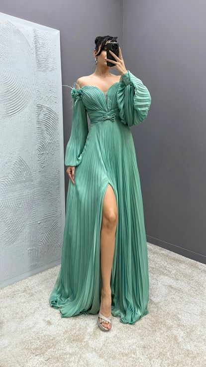 Mintgrünes Kleid mit Federapplikationen an den Schultern  Ballonärmeln und Faltenwurf 