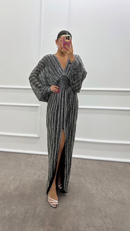 Abito da sera firmato con maniche a pipistrello argentate e ricami a mano 