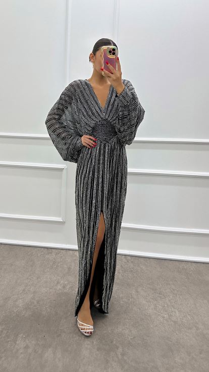 Abito da sera firmato con maniche a pipistrello argentate e ricami a mano 