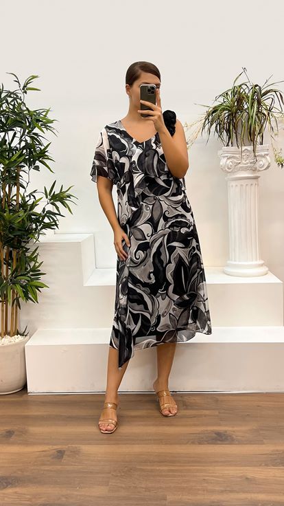 فستان سهرة أسود بمقاسات كبيرة، بياقة على شكل حرف V ونقوش مميزة