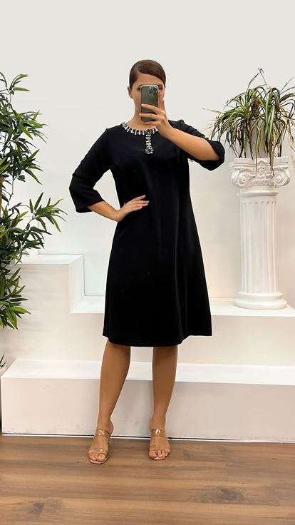 فستان سهرة أسود بمقاسات كبيرة وياقة دائرية مزينة بتطريز على خط العنق