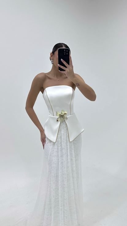 فستان سهرة بتنورة من الدانتيل العاجي وتفاصيل زهرية